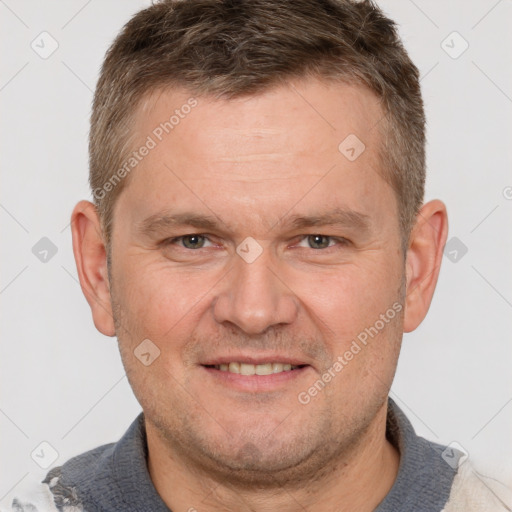 Joyful white adult male with short  brown hair and brown eyes