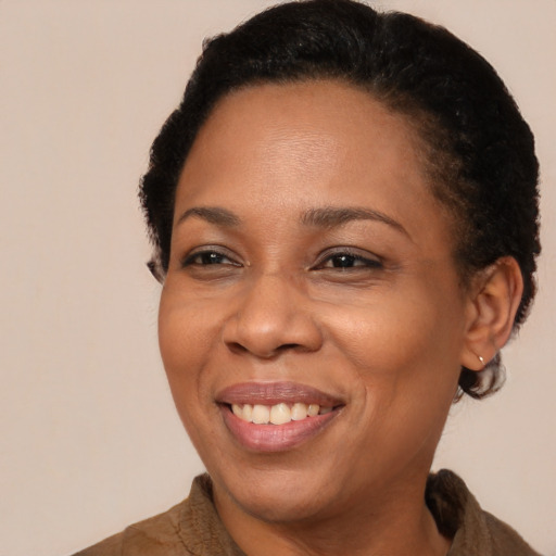 Joyful black adult female with short  brown hair and brown eyes