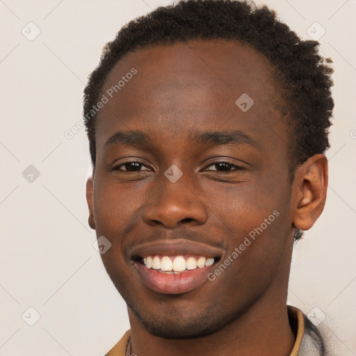 Joyful black young-adult male with short  brown hair and brown eyes