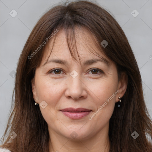 Joyful white adult female with long  brown hair and brown eyes