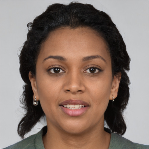 Joyful black young-adult female with short  black hair and brown eyes