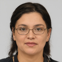 Joyful white adult female with medium  brown hair and grey eyes