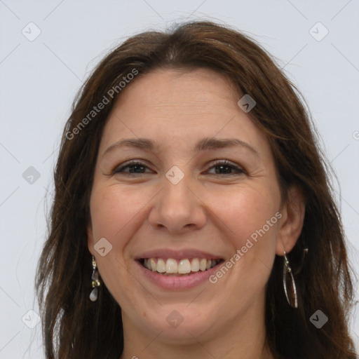 Joyful white adult female with long  brown hair and brown eyes