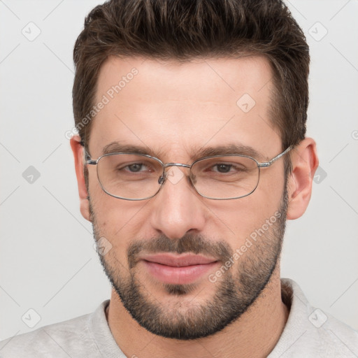 Joyful white adult male with short  brown hair and brown eyes