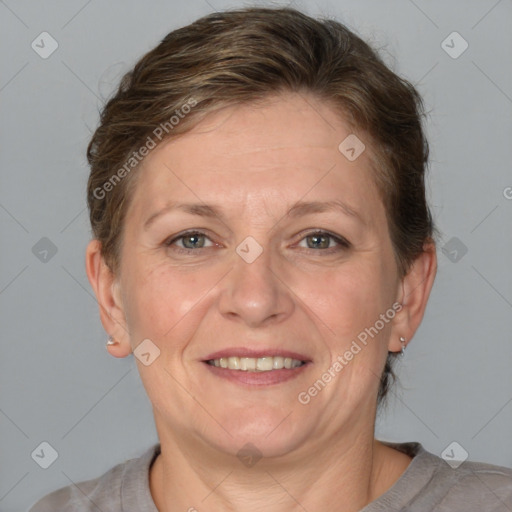 Joyful white adult female with medium  brown hair and grey eyes