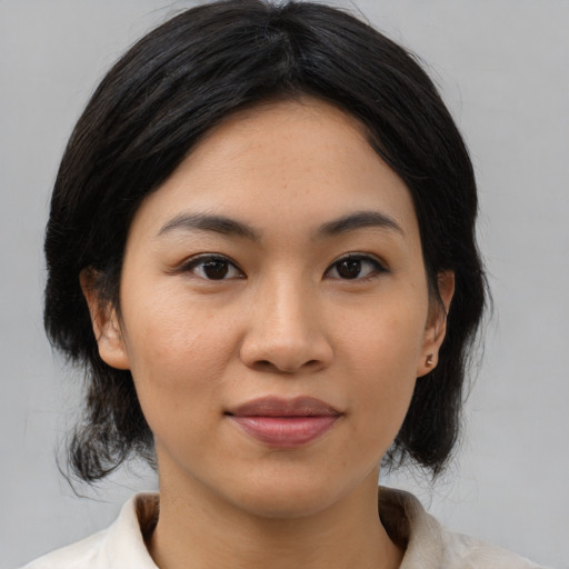Joyful asian young-adult female with medium  black hair and brown eyes