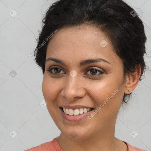 Joyful latino young-adult female with short  brown hair and brown eyes