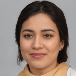 Joyful latino young-adult female with medium  brown hair and brown eyes