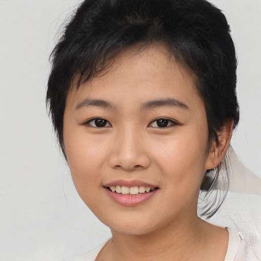 Joyful asian young-adult female with medium  black hair and brown eyes