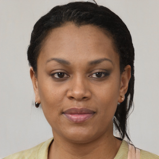 Joyful black young-adult female with short  brown hair and brown eyes