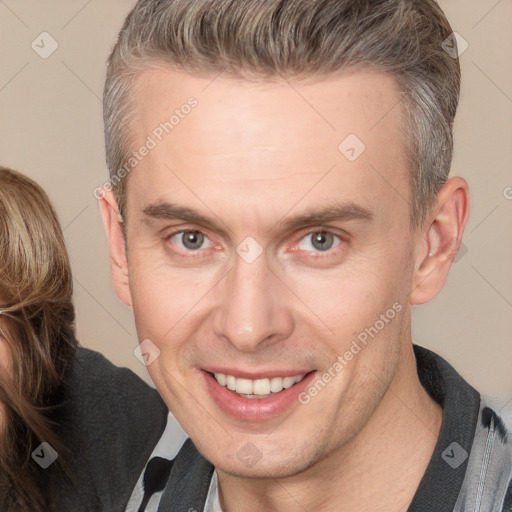 Joyful white adult male with short  brown hair and brown eyes