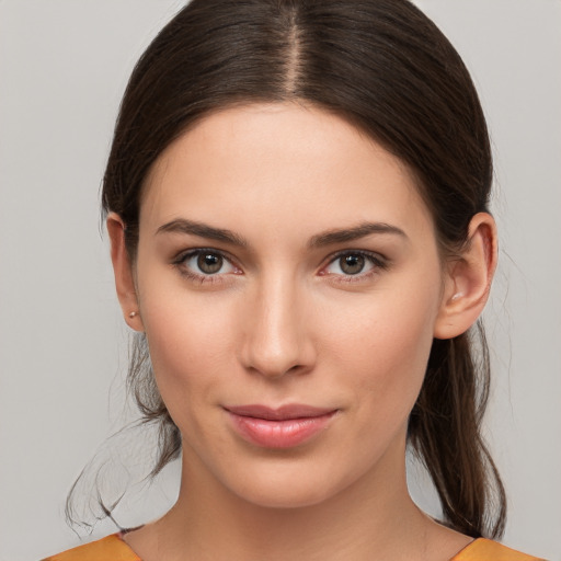 Joyful white young-adult female with medium  brown hair and brown eyes