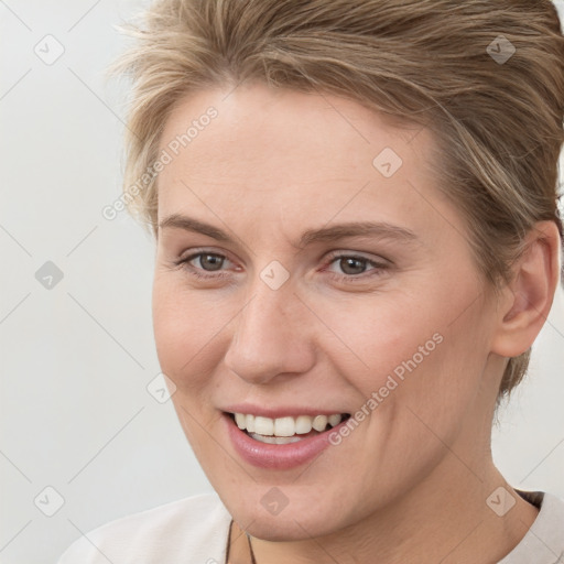 Joyful white young-adult female with short  brown hair and brown eyes