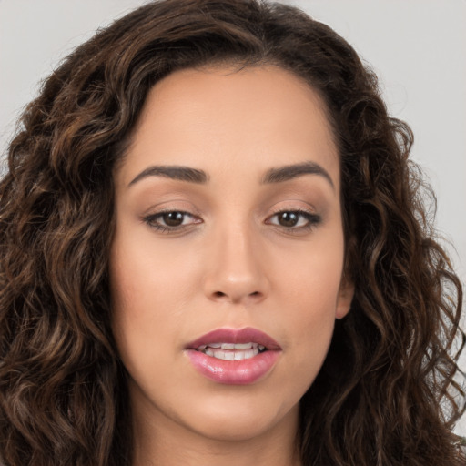 Joyful white young-adult female with long  brown hair and brown eyes