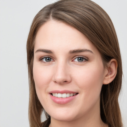 Joyful white young-adult female with long  brown hair and grey eyes