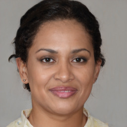 Joyful black adult female with short  brown hair and brown eyes