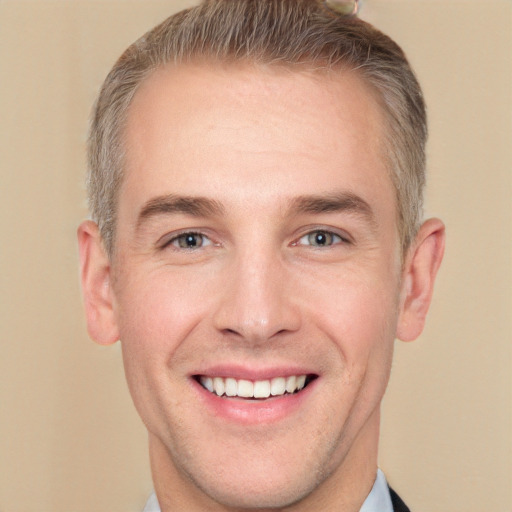 Joyful white adult male with short  brown hair and grey eyes