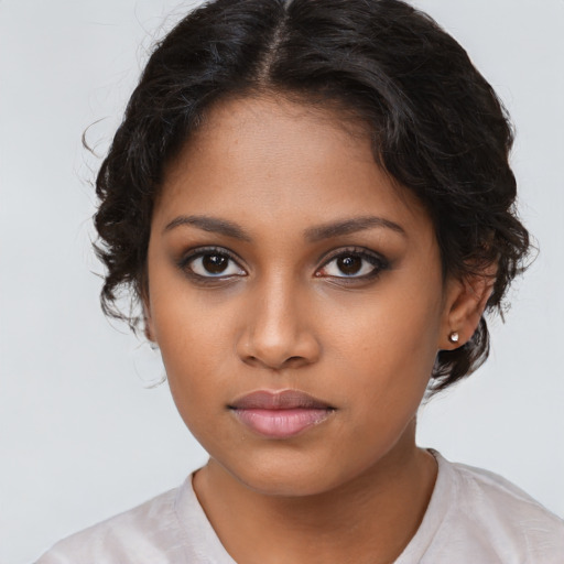 Neutral black young-adult female with medium  brown hair and brown eyes