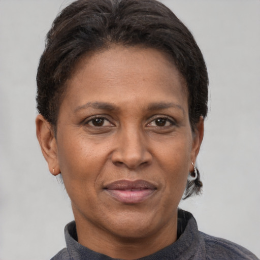 Joyful latino adult female with short  brown hair and brown eyes