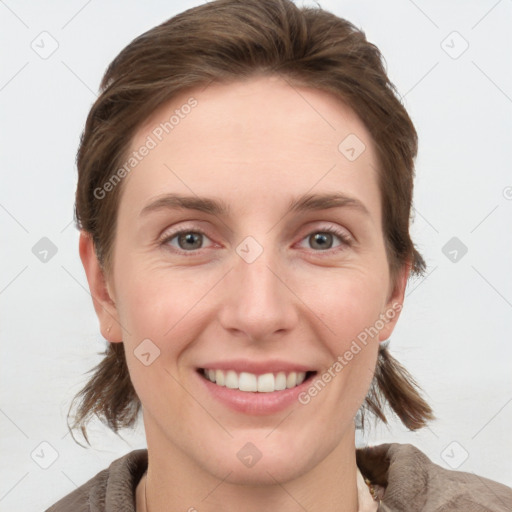 Joyful white young-adult female with medium  brown hair and grey eyes