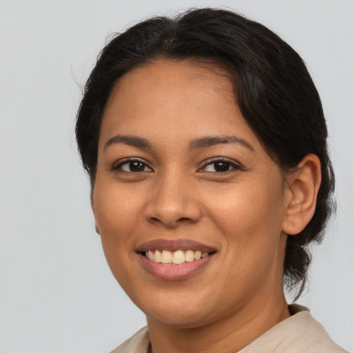 Joyful latino young-adult female with medium  brown hair and brown eyes