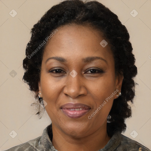 Joyful black adult female with medium  brown hair and brown eyes