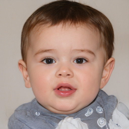 Joyful white child male with medium  brown hair and brown eyes