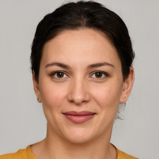 Joyful white young-adult female with medium  brown hair and brown eyes