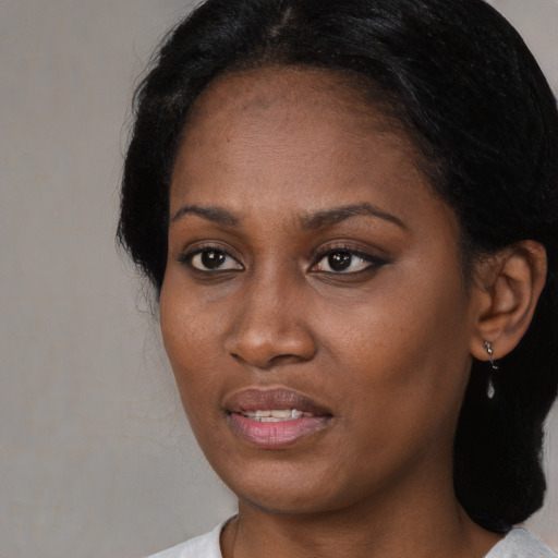 Joyful black young-adult female with medium  black hair and brown eyes