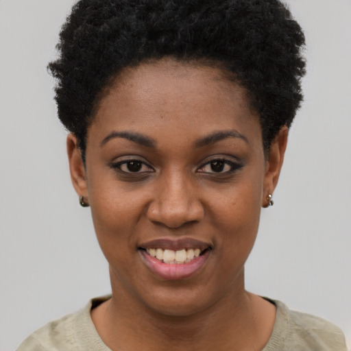 Joyful black young-adult female with short  black hair and brown eyes