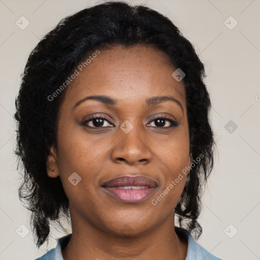 Joyful black adult female with medium  brown hair and brown eyes