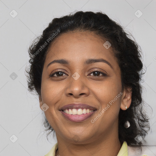 Joyful black adult female with long  black hair and brown eyes