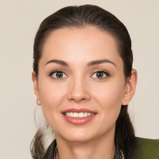 Joyful white young-adult female with long  brown hair and brown eyes