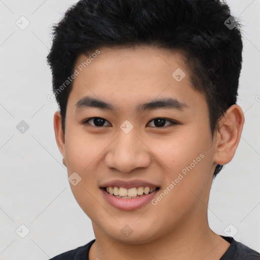 Joyful asian young-adult male with short  brown hair and brown eyes