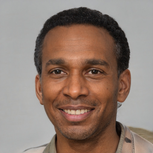 Joyful latino adult male with short  black hair and brown eyes