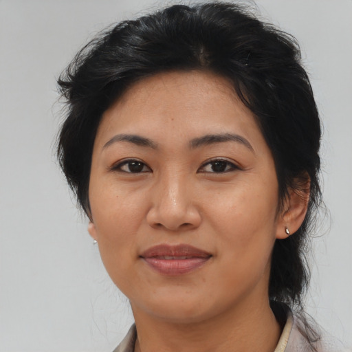 Joyful asian adult female with medium  black hair and brown eyes