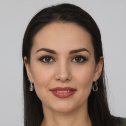 Joyful white young-adult female with long  brown hair and brown eyes