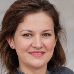 Joyful white adult female with medium  brown hair and grey eyes