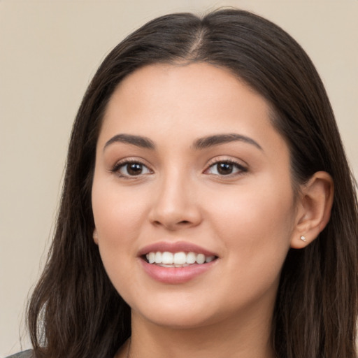 Joyful white young-adult female with long  brown hair and brown eyes