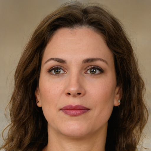 Joyful white young-adult female with long  brown hair and green eyes