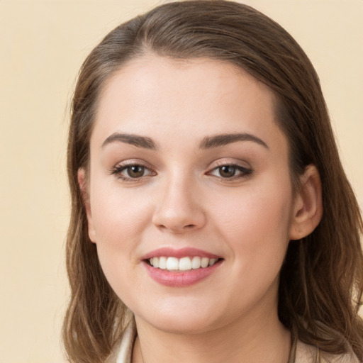 Joyful white young-adult female with long  brown hair and brown eyes