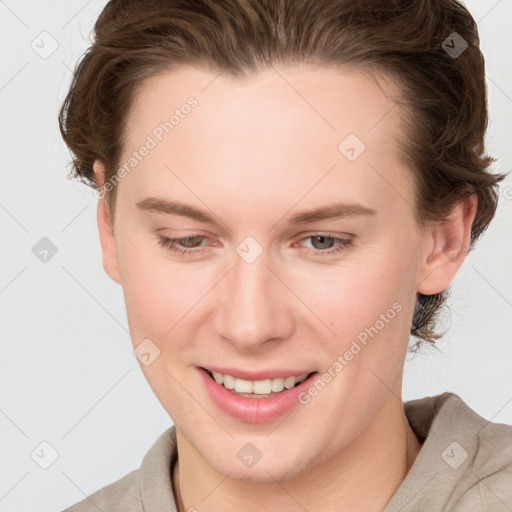 Joyful white young-adult female with short  brown hair and blue eyes