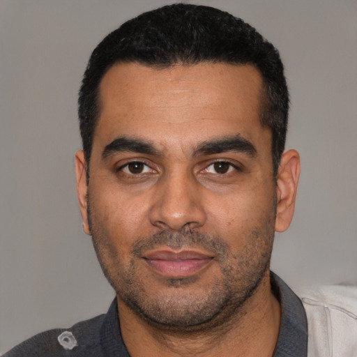 Neutral latino young-adult male with short  black hair and brown eyes