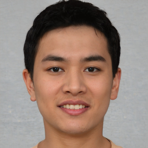 Joyful asian young-adult male with short  black hair and brown eyes