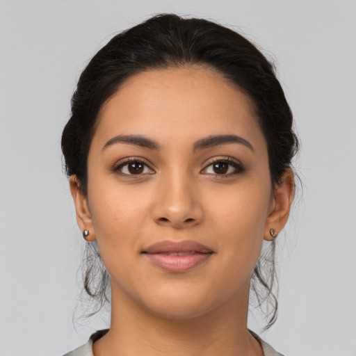 Joyful latino young-adult female with medium  brown hair and brown eyes