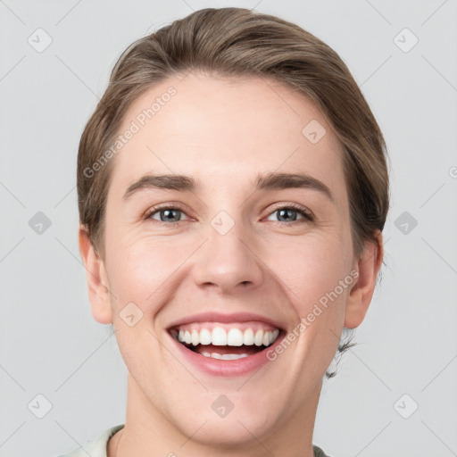 Joyful white young-adult female with short  brown hair and grey eyes