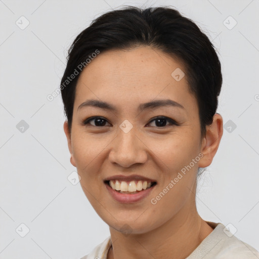 Joyful asian young-adult female with short  black hair and brown eyes