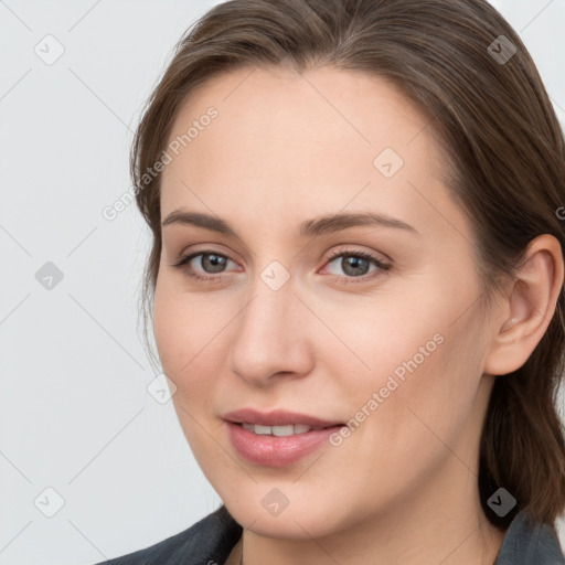 Joyful white young-adult female with medium  brown hair and blue eyes