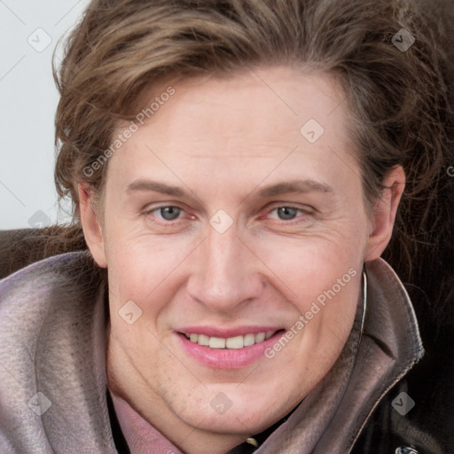 Joyful white adult female with long  brown hair and grey eyes