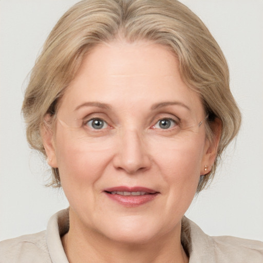 Joyful white adult female with medium  brown hair and blue eyes